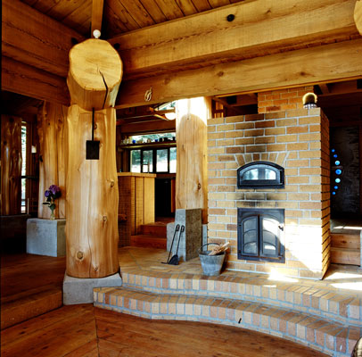 The home's primary heat source is a clean-burning masonry stove; when fired in the morning, it holds and releases heat throughout the day.